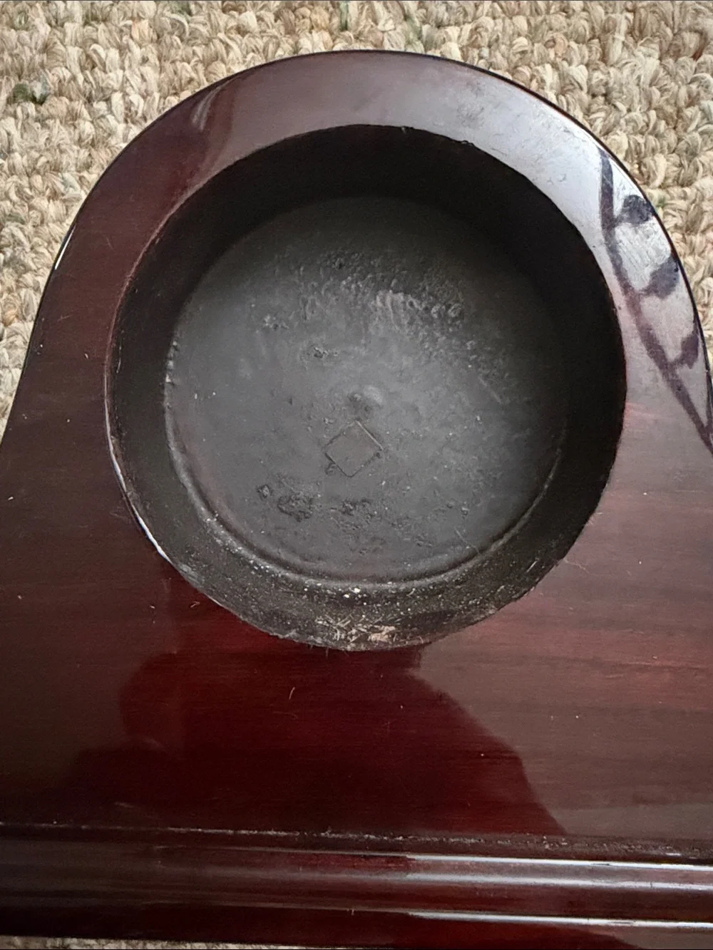 empty, polished wooden mantel clock case with a traditional arched profile
